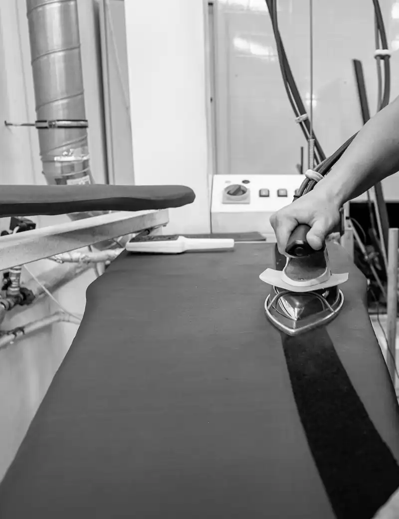 A garment being pressed on an industrial press